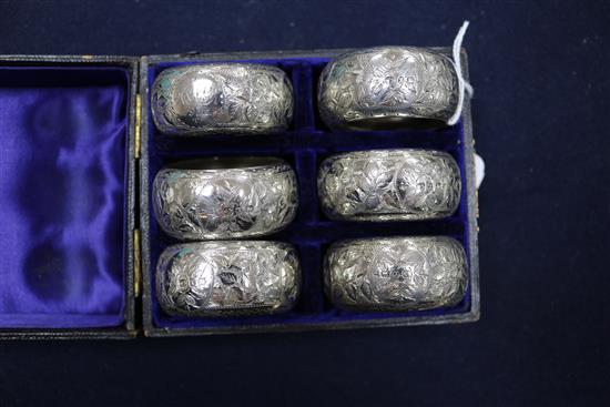 A cased set of six late Victorian silver napkin rings, Birmingham, 1897, a later pair and two other napkin rings.